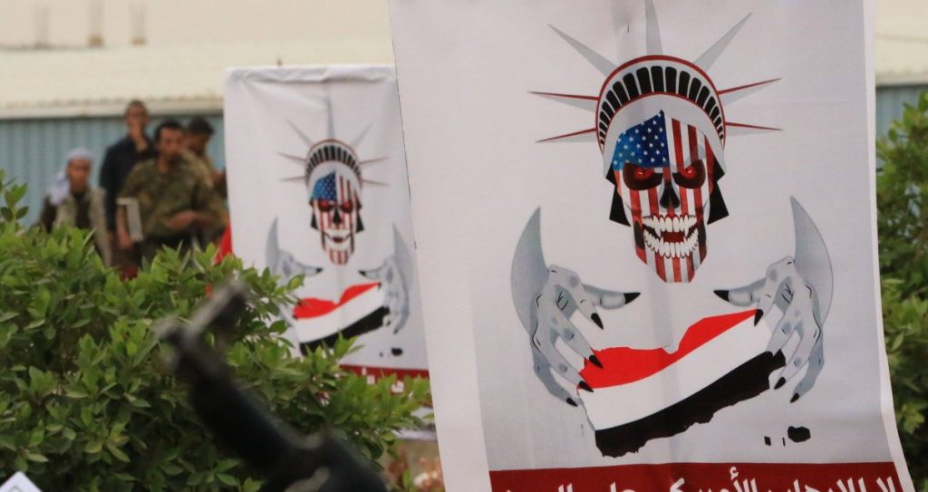 Poster dengan ilustrasi tengkorak dan bendera Irak.
